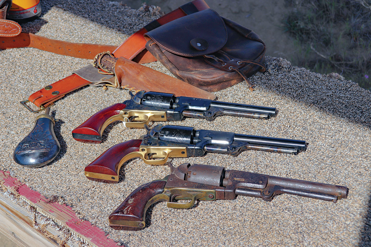 From bottom to top, an original 1st Model Dragoon, a 3rd Model Cimarron Dragoon and a Whitneyville replica from Cimarron. Note the cylinder stop notches on top and bottom.